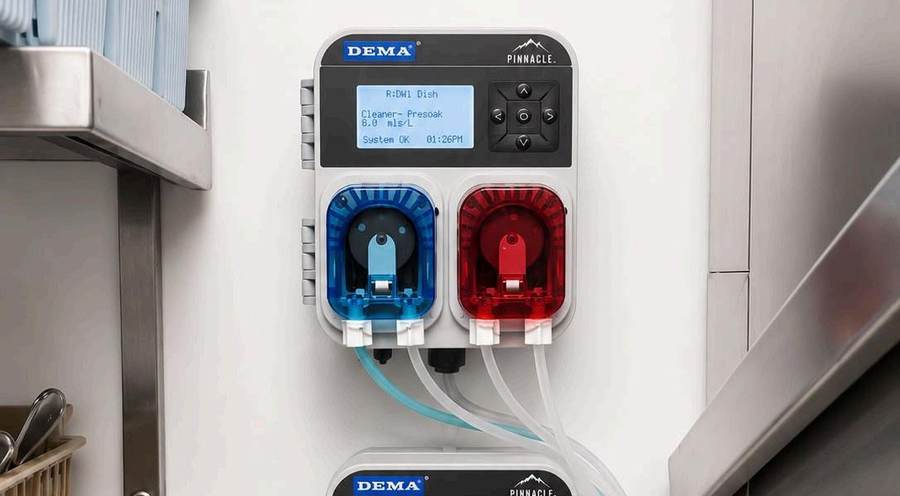 Cleaner Future precision dosing units mounted on a wall beside a commercial dishwasher